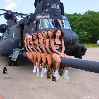 красивые девушки сидят рядом с вертолетом
